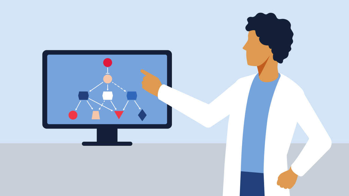 Person in a lab coat pointing at monitor screen