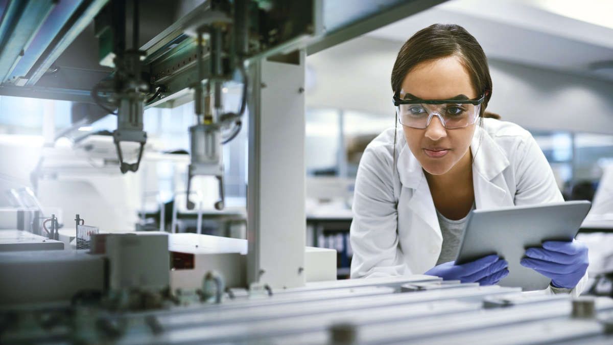 Fragment your DNA with ease, Female scientist watching an instrument, checking, control
